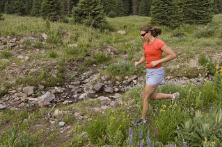 Gabby Anstey trail running the West Fork Trail in the San Juan Mountains. Big Blue Wilderness, Colorado.